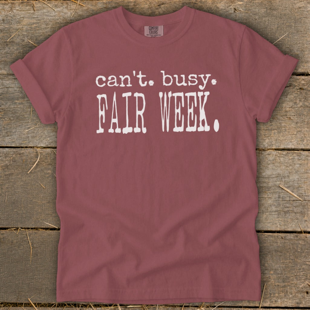 Maroon t-shirt with white text that reads "can't. busy. FAIR WEEK."