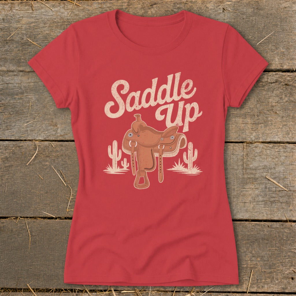 Red t-shirt with "Saddle Up" text and cowboy saddle with cacti graphic.