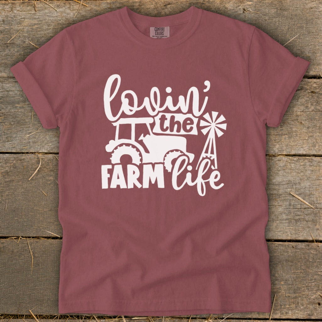 Maroon t-shirt with white graphic of tractor, windmill, and text "lovin' the Farm Life".