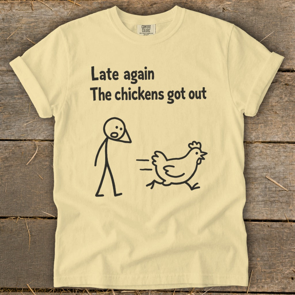 Light yellow t-shirt with "Late again The chickens got out" text and stick figure chasing a chicken.