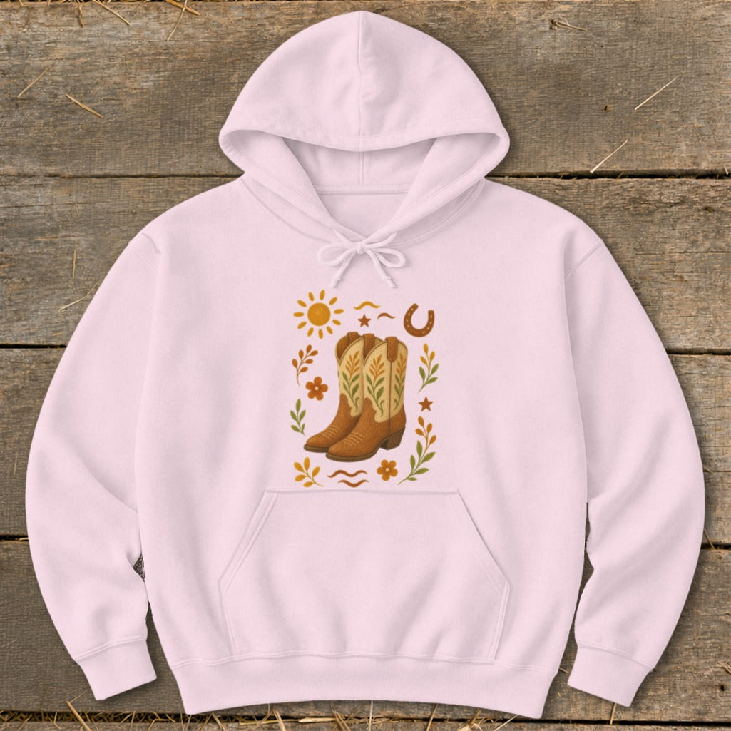 Light pink hoodie with a central graphic of cowboy boots surrounded by western motifs.