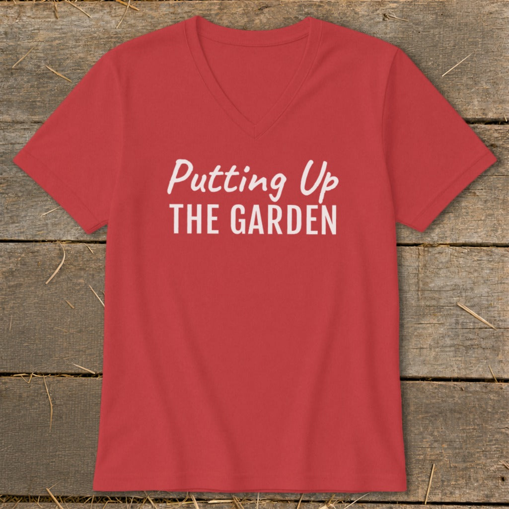Red v-neck t-shirt with white text "Putting Up THE GARDEN".
