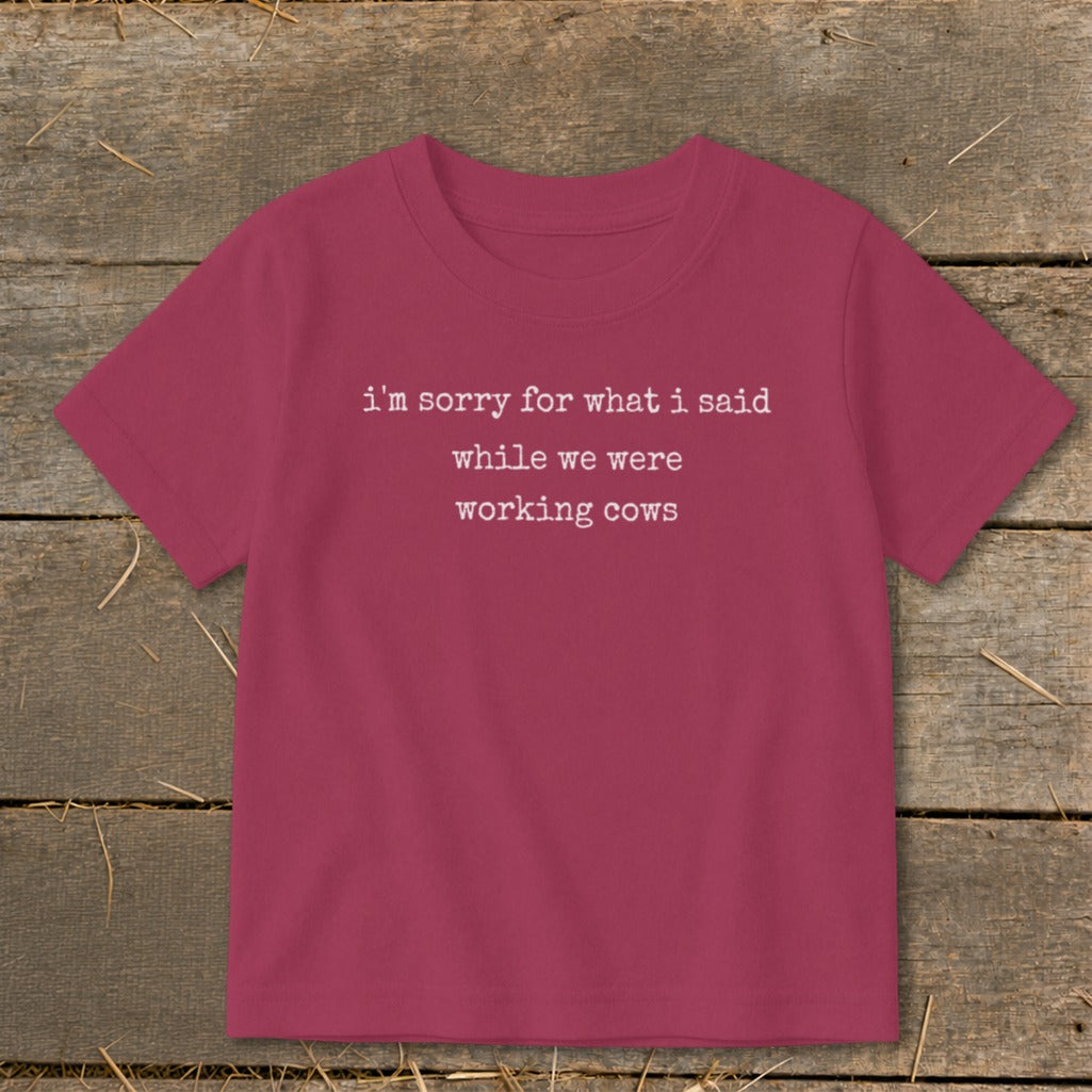 Maroon t-shirt with white text: "i'm sorry for what i said while we were working cows."