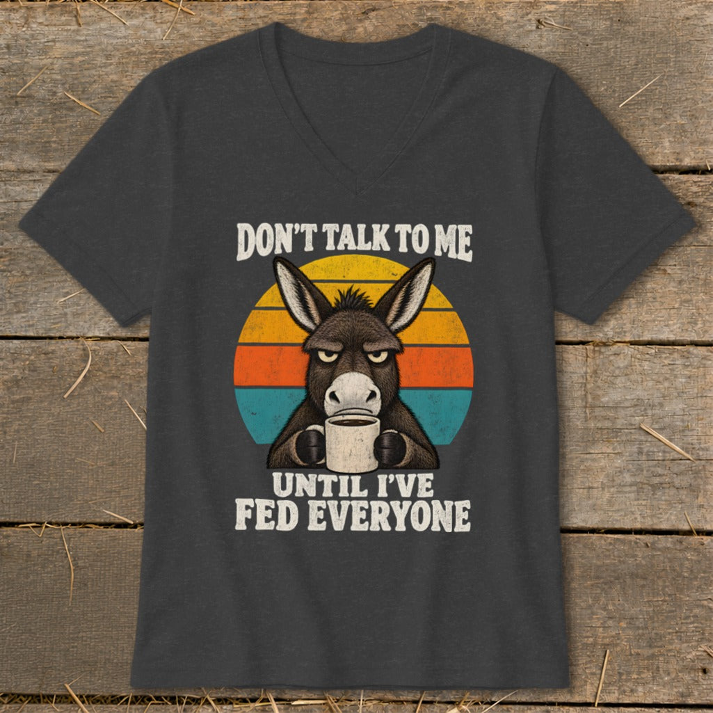 Dark gray V-neck t-shirt featuring a graphic of a grumpy donkey holding a coffee mug.