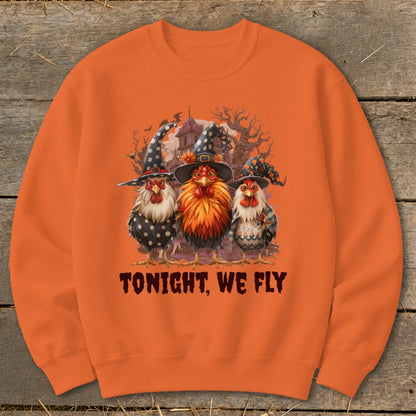 Three chickens wear witch hats and Halloween costumes with text "Tonight, We Fly".