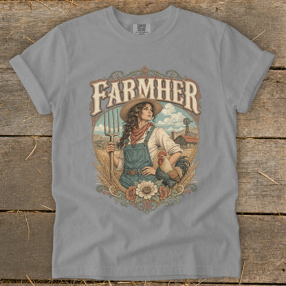 T-shirt graphic of a farmer woman with pitchfork, chicken, and farm in background.