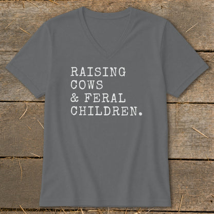 Grey v-neck t-shirt with white text: Raising Cows & Feral Children.