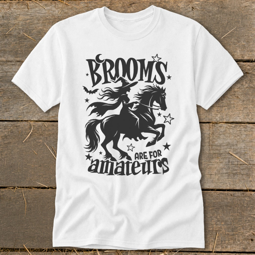 White t-shirt with witch riding a horse and "Brooms are for amateurs" text.