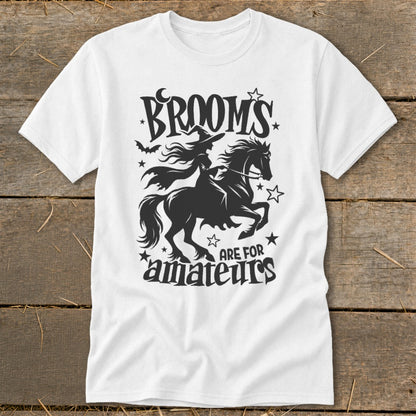 White t-shirt with witch riding a horse and "Brooms are for amateurs" text.