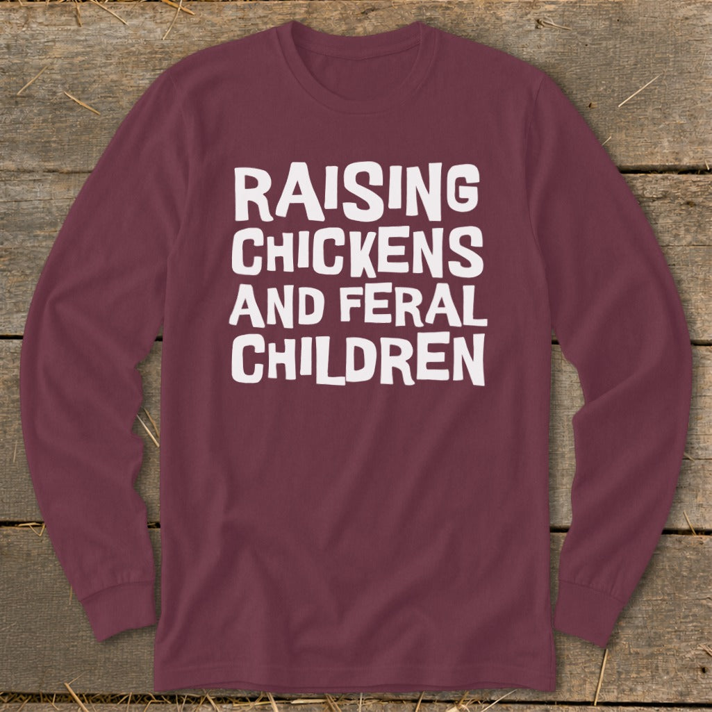 Maroon long-sleeve shirt with white text "Raising Chickens and Feral Children."