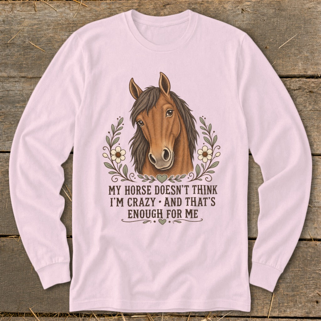 Pink long-sleeve shirt with a horse head graphic and the text "My horse doesn't think I'm crazy and that's enough for me."