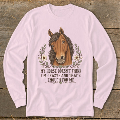 Pink long-sleeve shirt with a horse head graphic and the text "My horse doesn't think I'm crazy and that's enough for me."