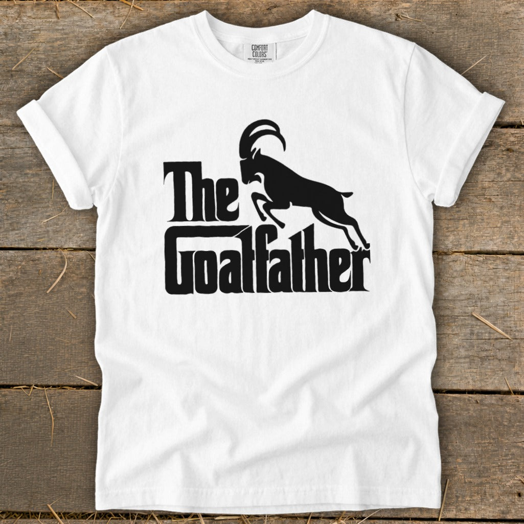 White t-shirt with black text "The Goatfather" and silhouette of a goat.