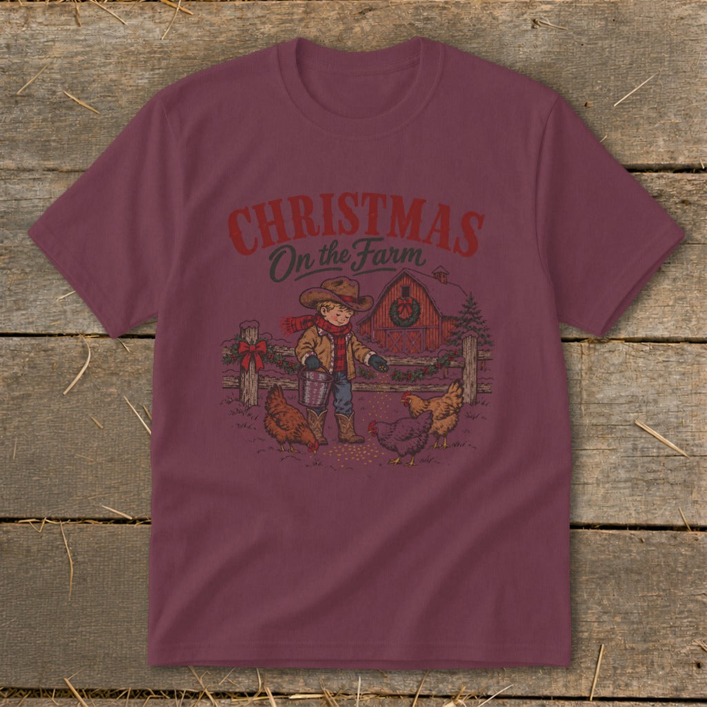Maroon short-sleeved t-shirt featuring a retro graphic of a child feeding chickens outside a barn.