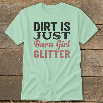 Light green t-shirt with black and pink text reading "DIRT IS JUST Barn Girl GLITTER".