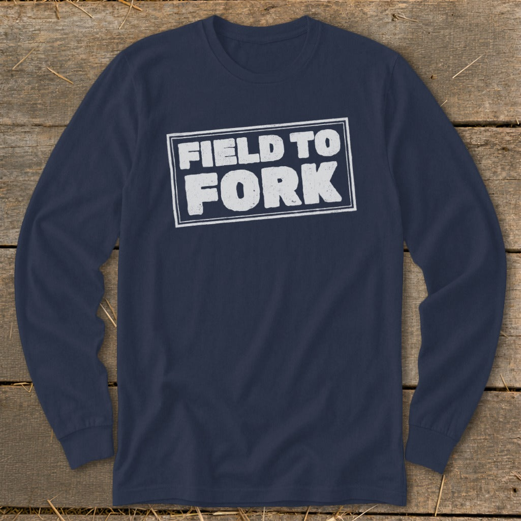 Navy blue long-sleeve t-shirt with a white rectangular border enclosing the text FIELD TO FORK.