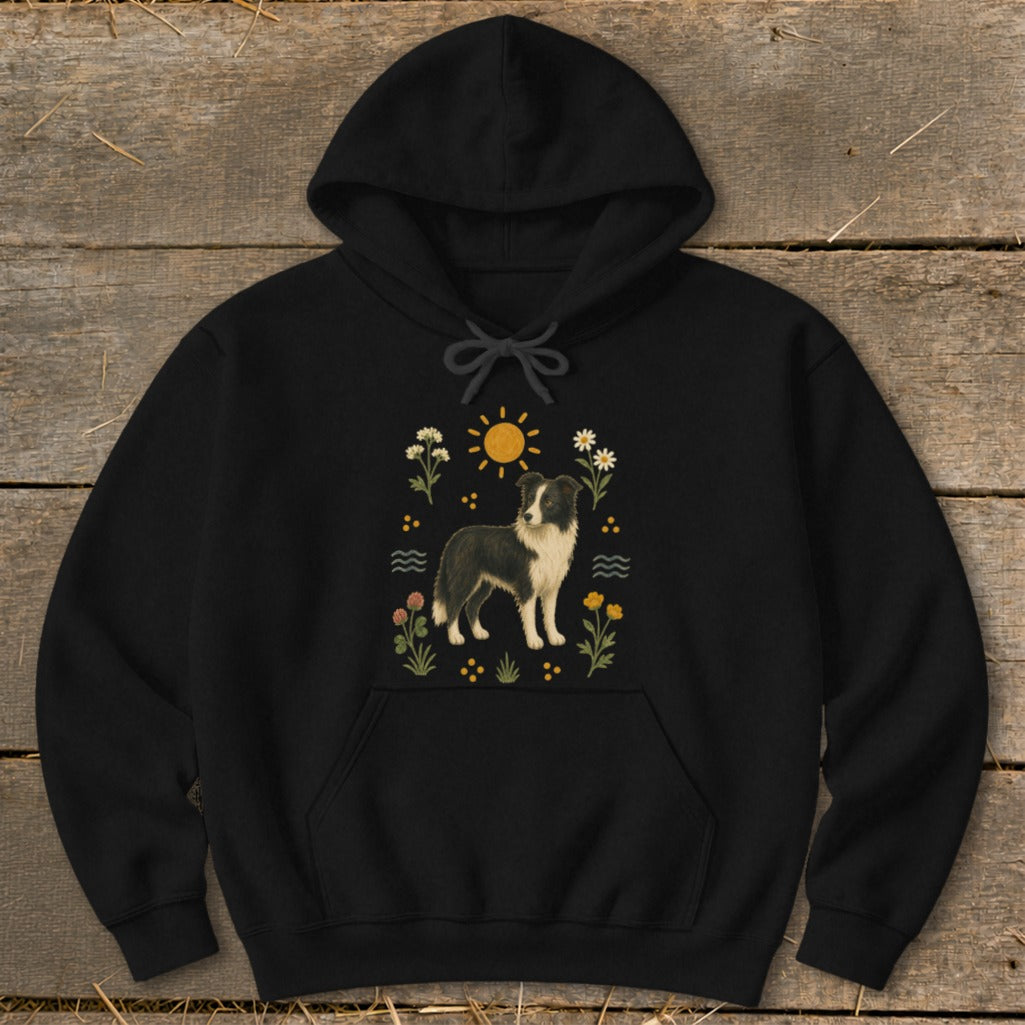 Black hoodie with a Border Collie illustration surrounded by flowers and sun.