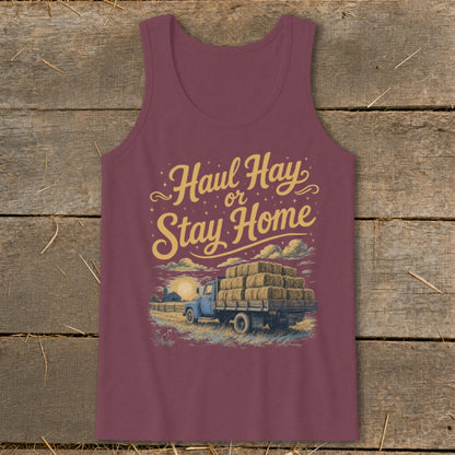Burgundy tank top with "Haul Hay or Stay Home" text and truck loaded with hay bales.