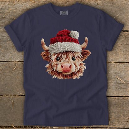 T-shirt with a cartoon Highland cow wearing a Santa hat.