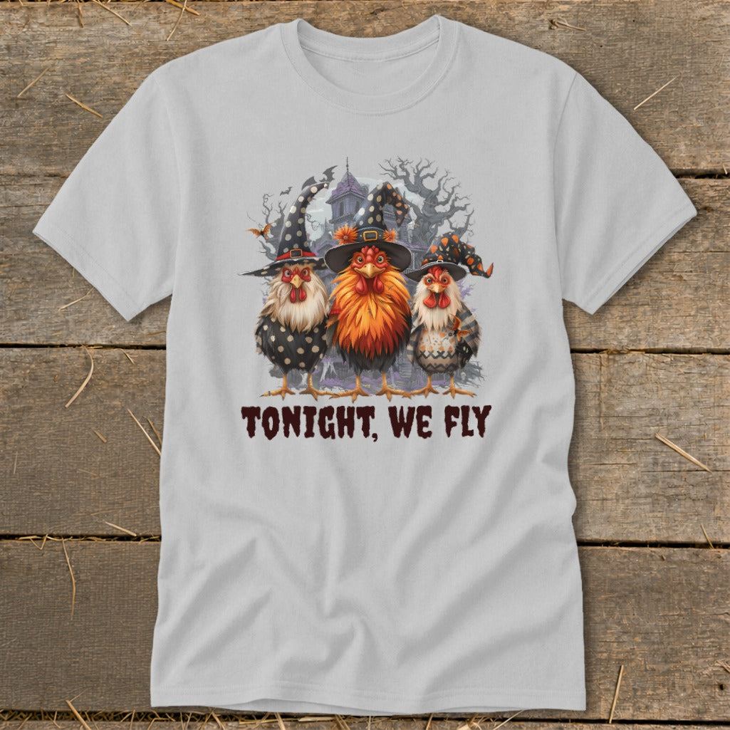 Three chickens in witch hats stand before a haunted house, with text "TONIGHT, WE FLY".
