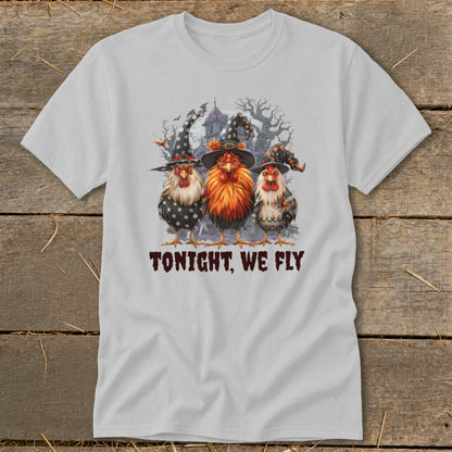 Three chickens in witch hats stand before a haunted house, with text "TONIGHT, WE FLY".