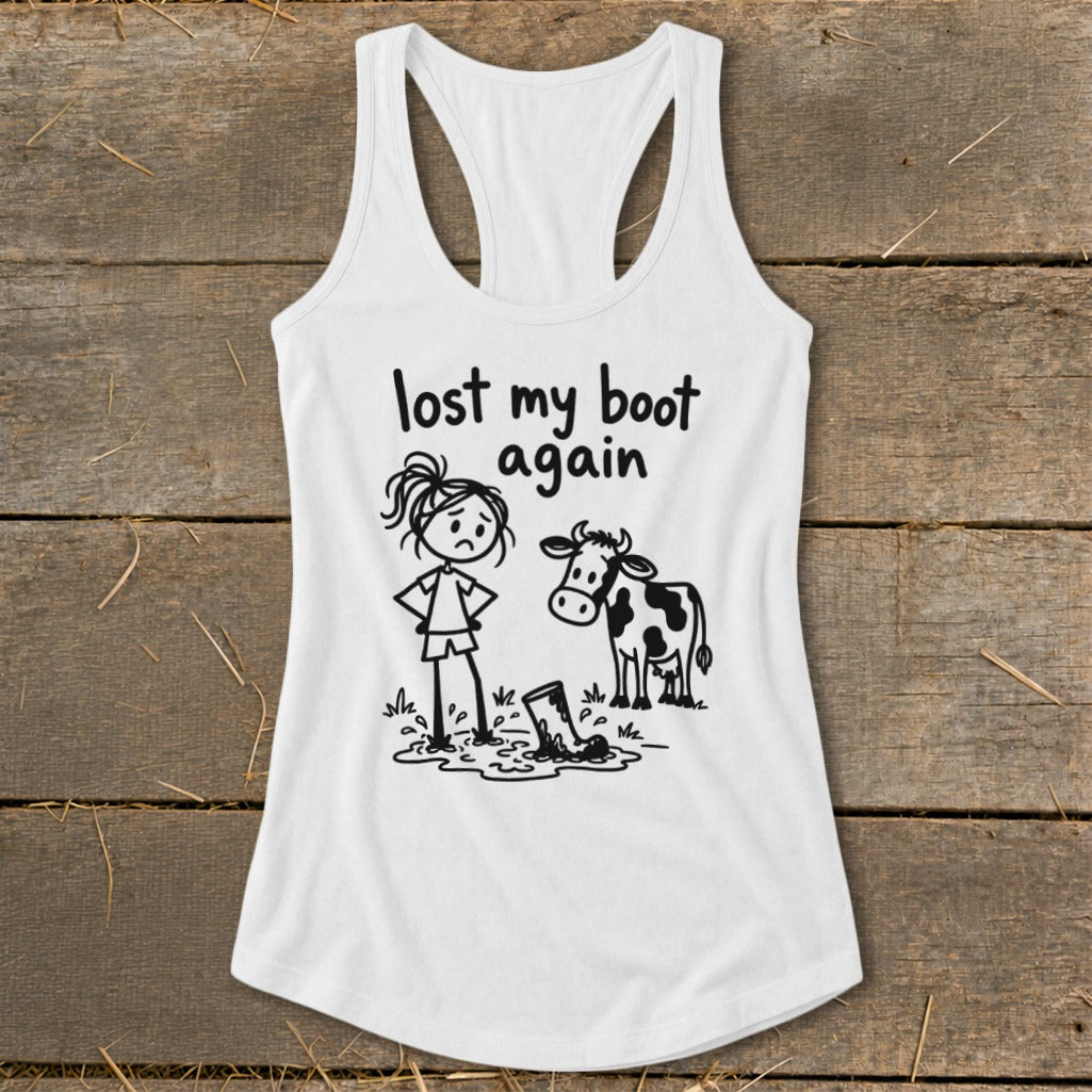A white racerback tank top with a graphic of a girl, cow, and muddy boot.