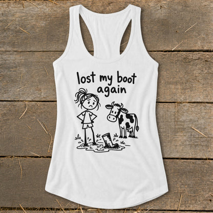 A white racerback tank top with a graphic of a girl, cow, and muddy boot.