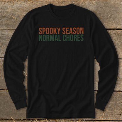 Black long-sleeve shirt with orange "SPOOKY SEASON" and green "NORMAL CHORES" text.