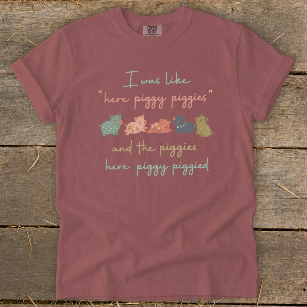 "Here piggy piggies" text with a line of small, colorful pigs.