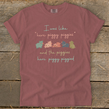 "Here piggy piggies" text with a line of small, colorful pigs.