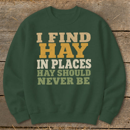 Green sweatshirt with text "I FIND HAY IN PLACES HAY SHOULD NEVER BE".