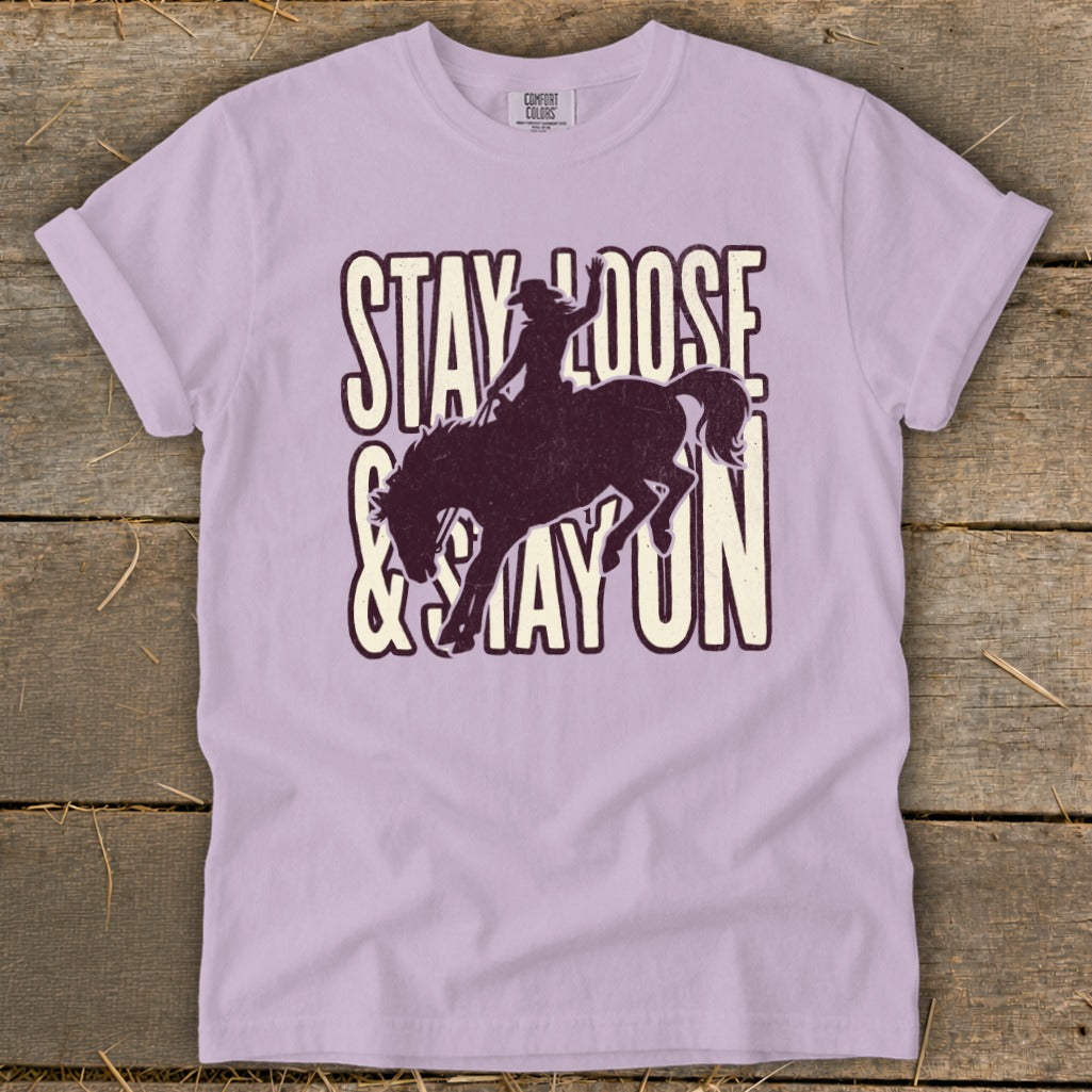 Purple t-shirt with "Stay Loose & Stay On" and a bucking bronco graphic.