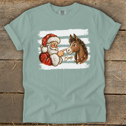 Santa boops a horse's nose with the word "Boop" in cursive.