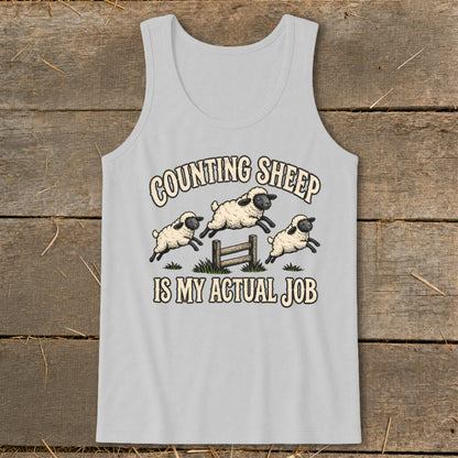 Gray tank top with "Counting Sheep Is My Actual Job" text and three jumping sheep.