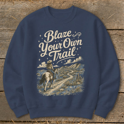 Navy sweatshirt with "Blaze Your Own Trail" text and desert landscape with horse rider.