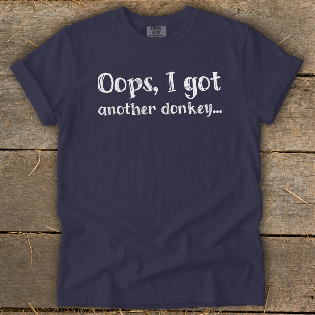 Navy blue t-shirt with white text reading "Oops, I got another donkey..."