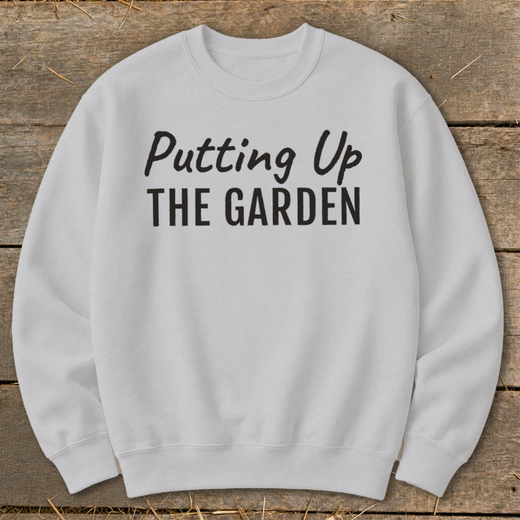 Light gray crewneck sweatshirt with black text "Putting Up THE GARDEN".