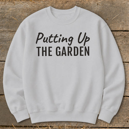 Light gray crewneck sweatshirt with black text "Putting Up THE GARDEN".