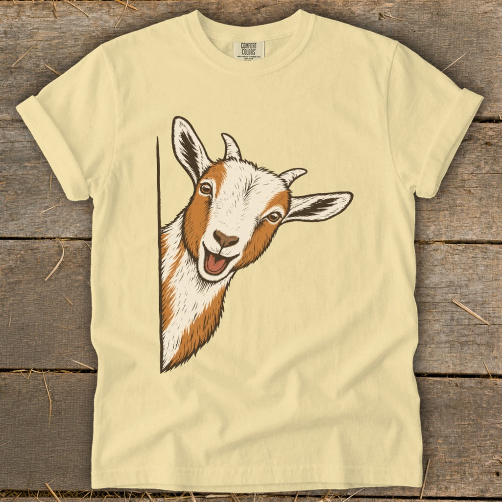 Cream t-shirt with a graphic of a curious goat peeking from the side.