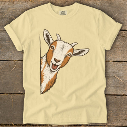 Cream t-shirt with a graphic of a curious goat peeking from the side.