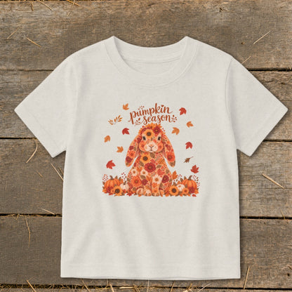 T-shirt with floral bunny and "Pumpkin Season" text, surrounded by autumn leaves and pumpkins.