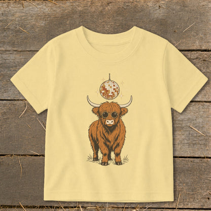 Fluffy Highland cow wearing sunglasses with a disco ball above.