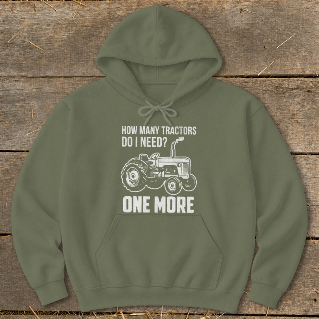 Olive green hoodie with graphic: "How many tractors do I need? One More" and a tractor illustration.