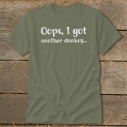 Olive green t-shirt with white text that reads "Oops, I got another donkey..."