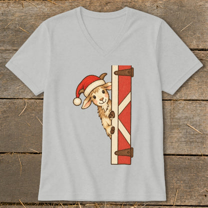 Christmas goat peeking from barn door on a light grey v-neck t-shirt.