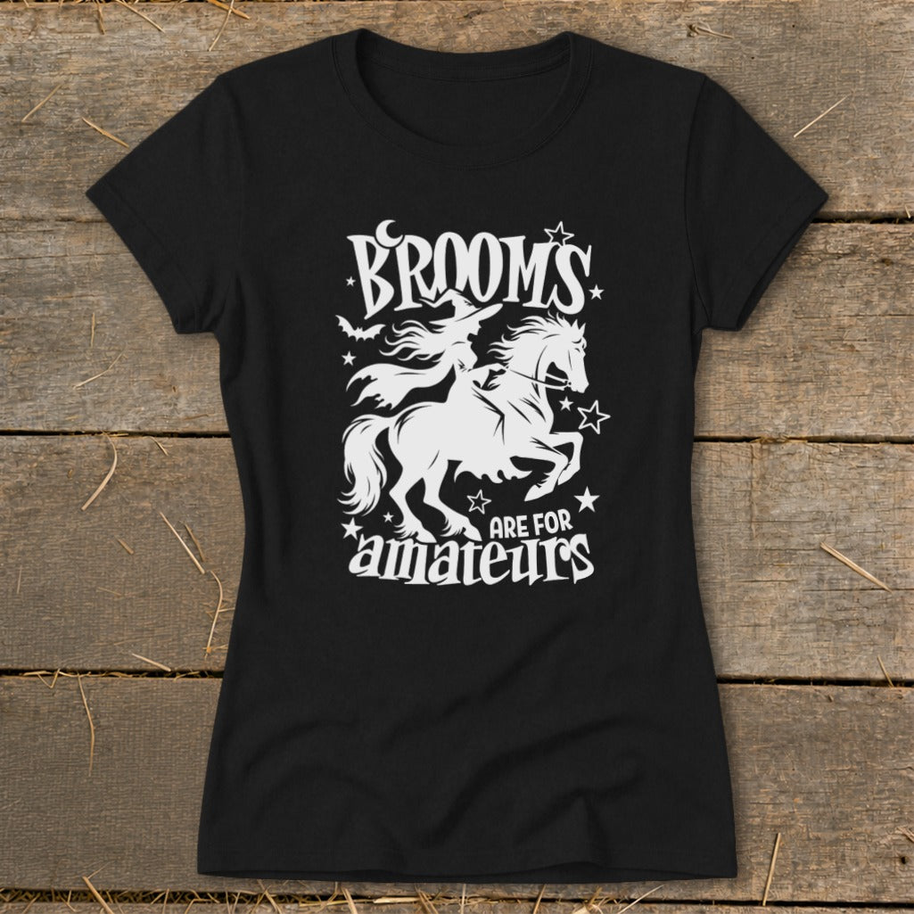 Black t-shirt with white graphic: witch on a horse, text "Brooms are for amateurs".