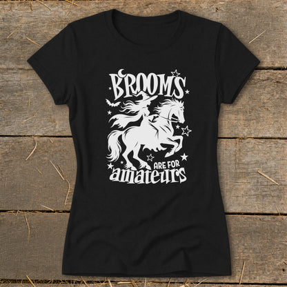 Black t-shirt with white graphic: witch on a horse, text "Brooms are for amateurs".