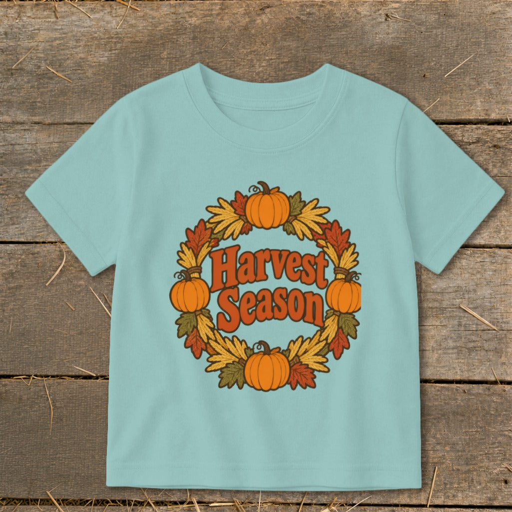 Light blue t-shirt with a wreath graphic and the text "Harvest Season".