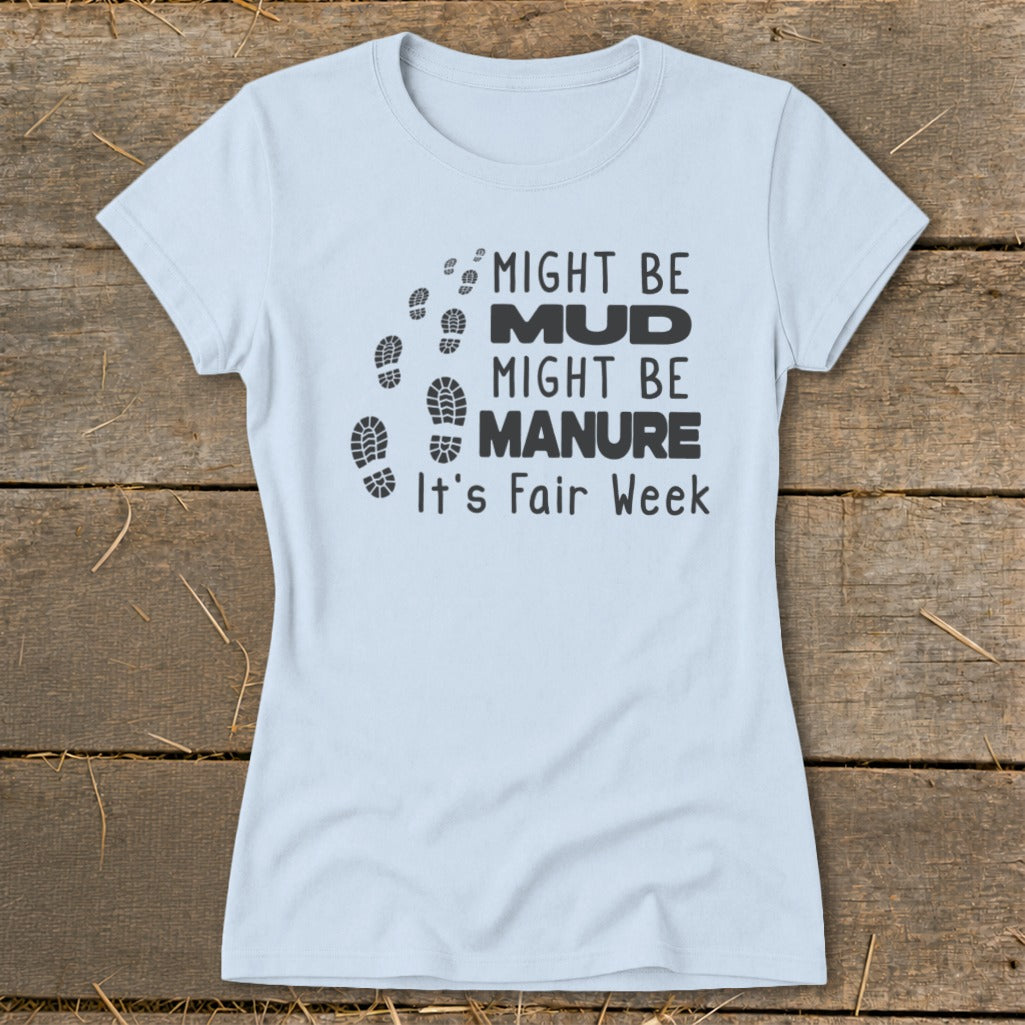Light blue t-shirt with black text and footprints: "Might be MUD, Might be MANURE. It's Fair Week."