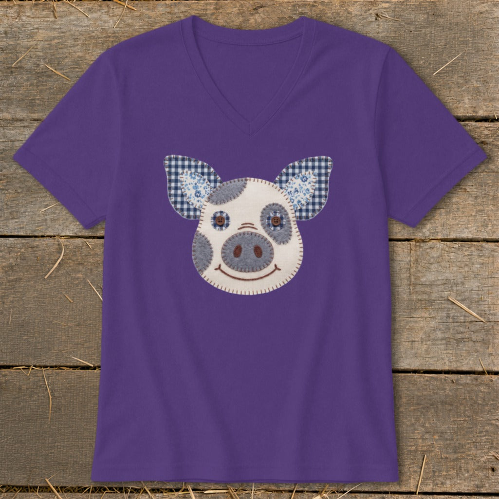 Purple t-shirt with a fabric applique pig face design.